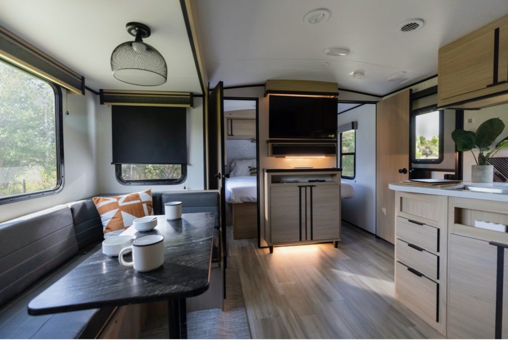 travel trailer with bunks behind couch