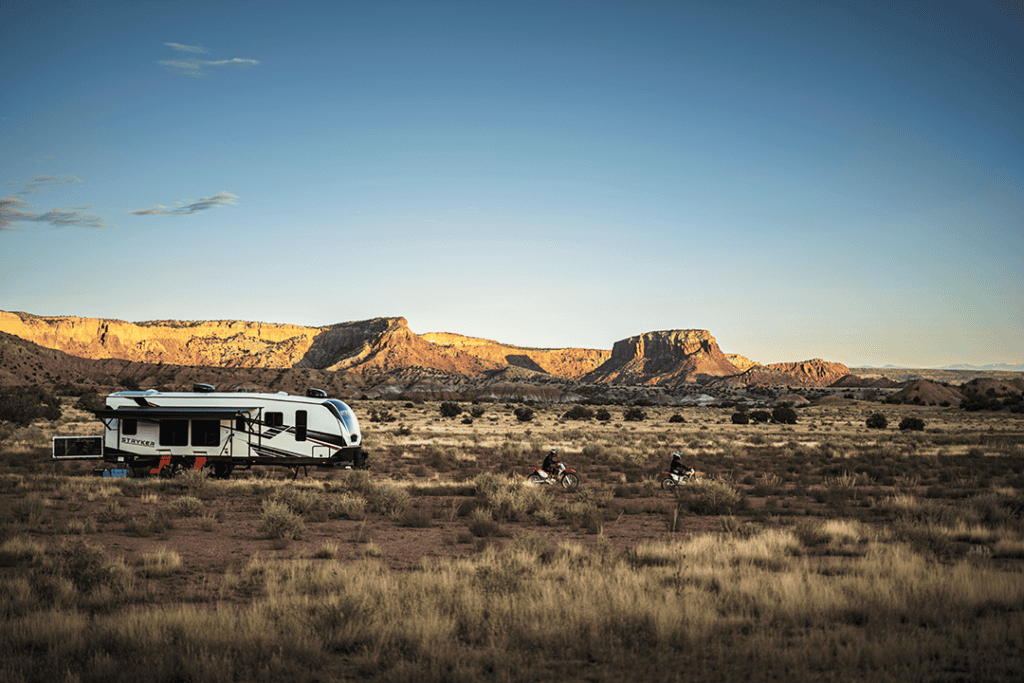 Exterior side view of a Stryker RV, highlighting its sleek design and spacious structure.